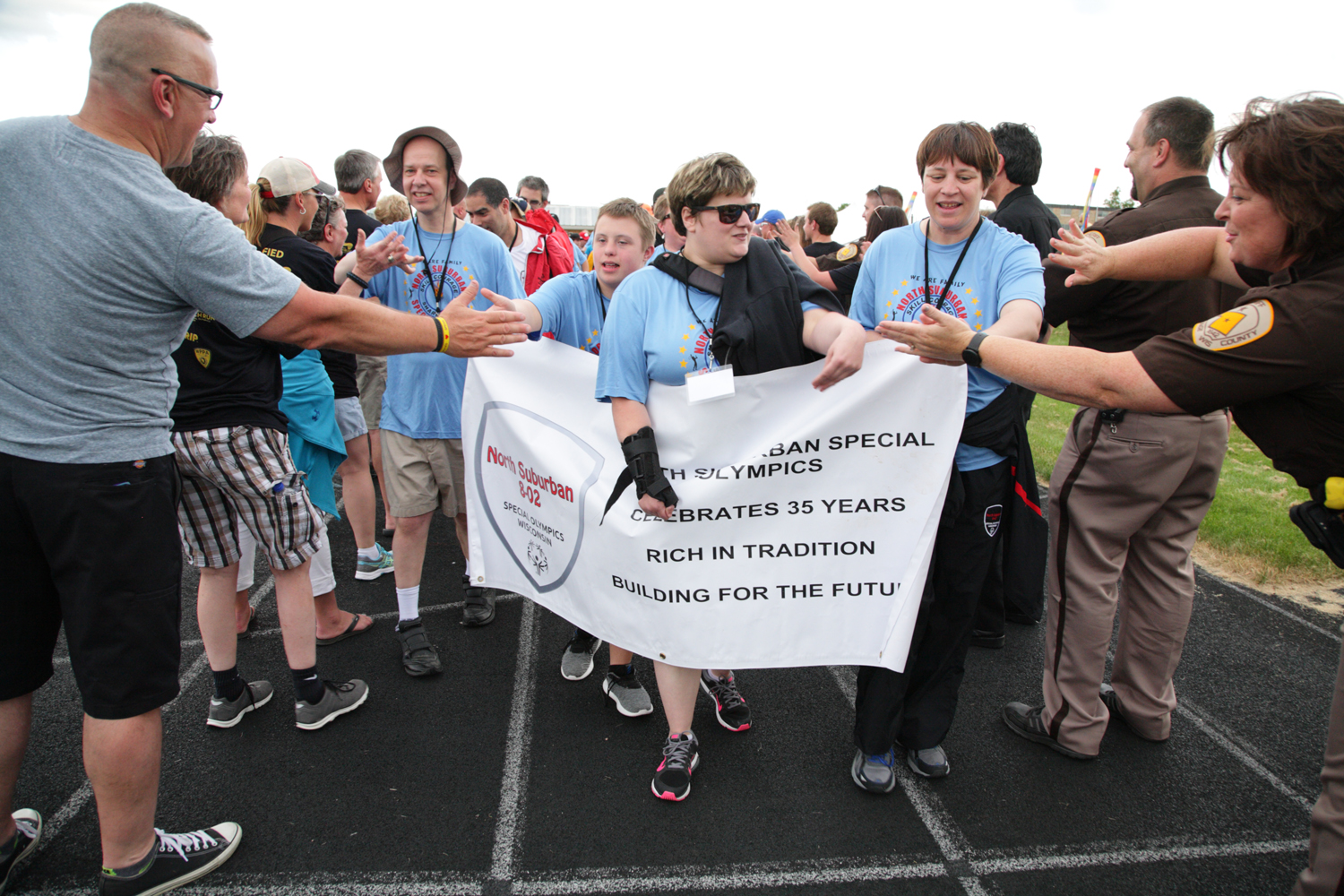 Raatz (center with sunglasses) leads her North Suburban team into the Opening Ceremony of the 2017 State Summer Games